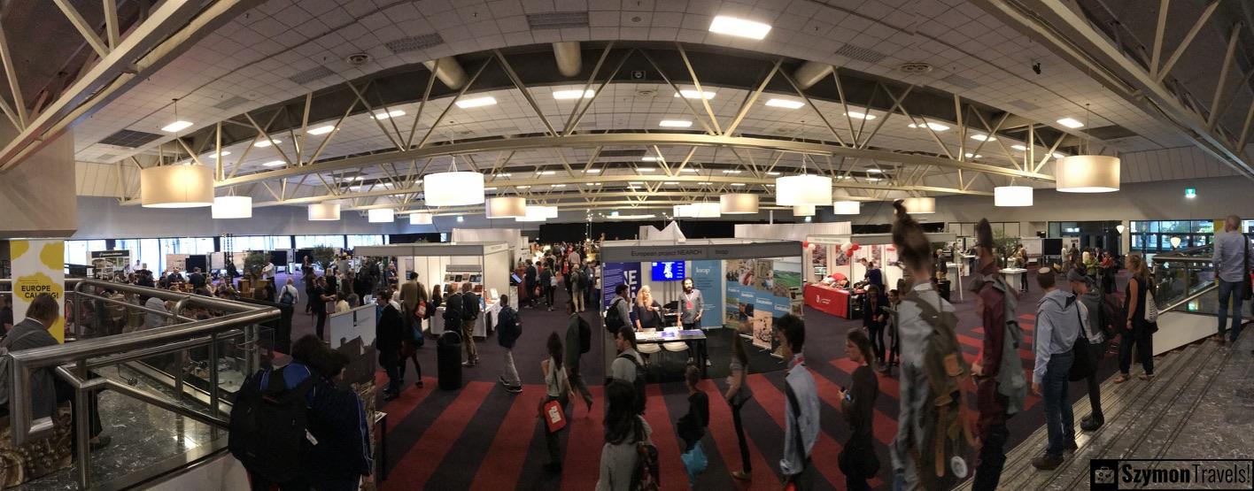 Panoramiczny widok hali konferencyjnej European Association of Archaeologists w Maastricht w 2017 roku, z uczestnikami i stoiskami.
