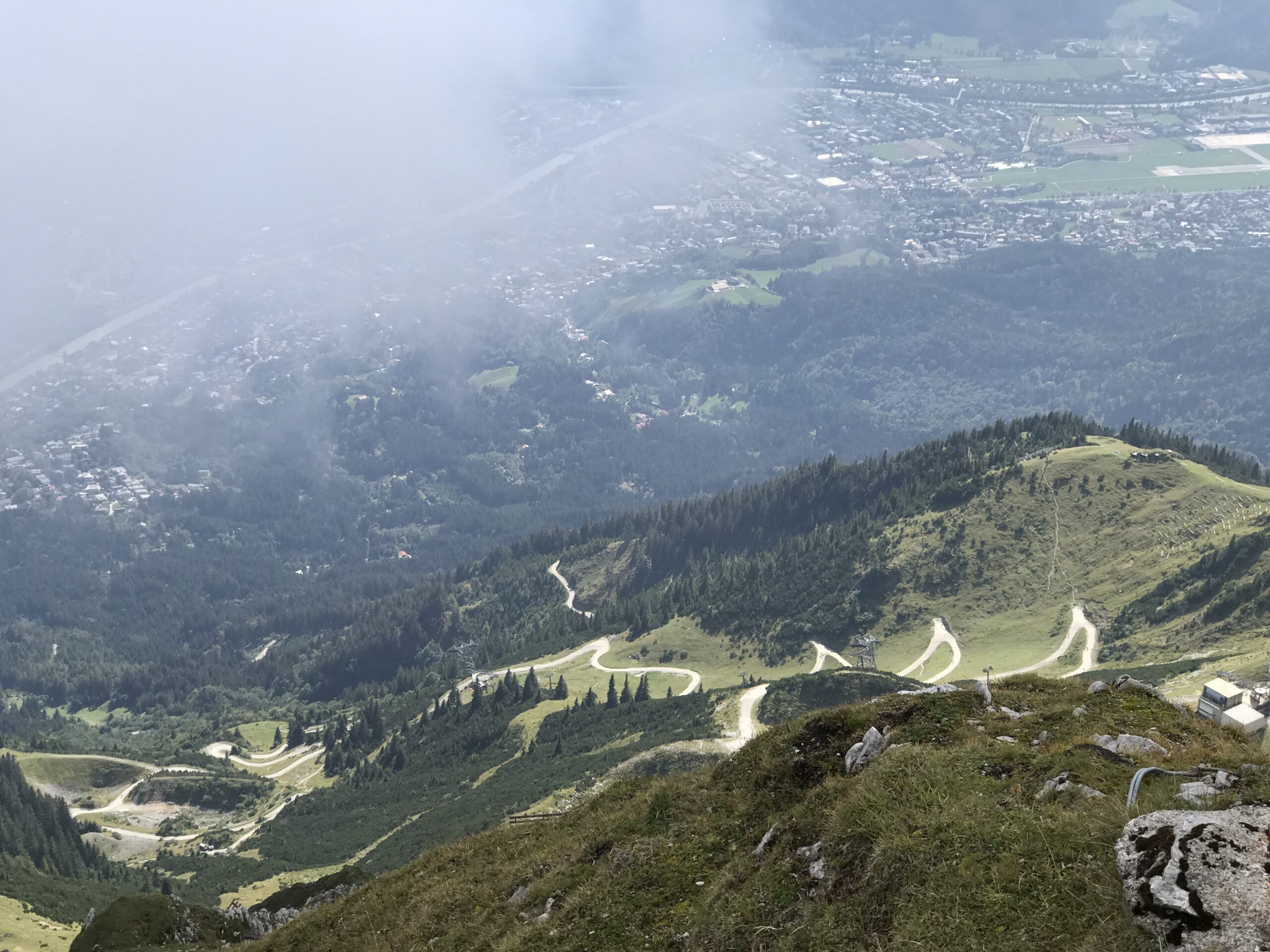 Widok z Nordkette na Innsbruck Widok z Nordkette na Innsbruck, dolinę Innu, kręte drogi i lasy pod chmurami