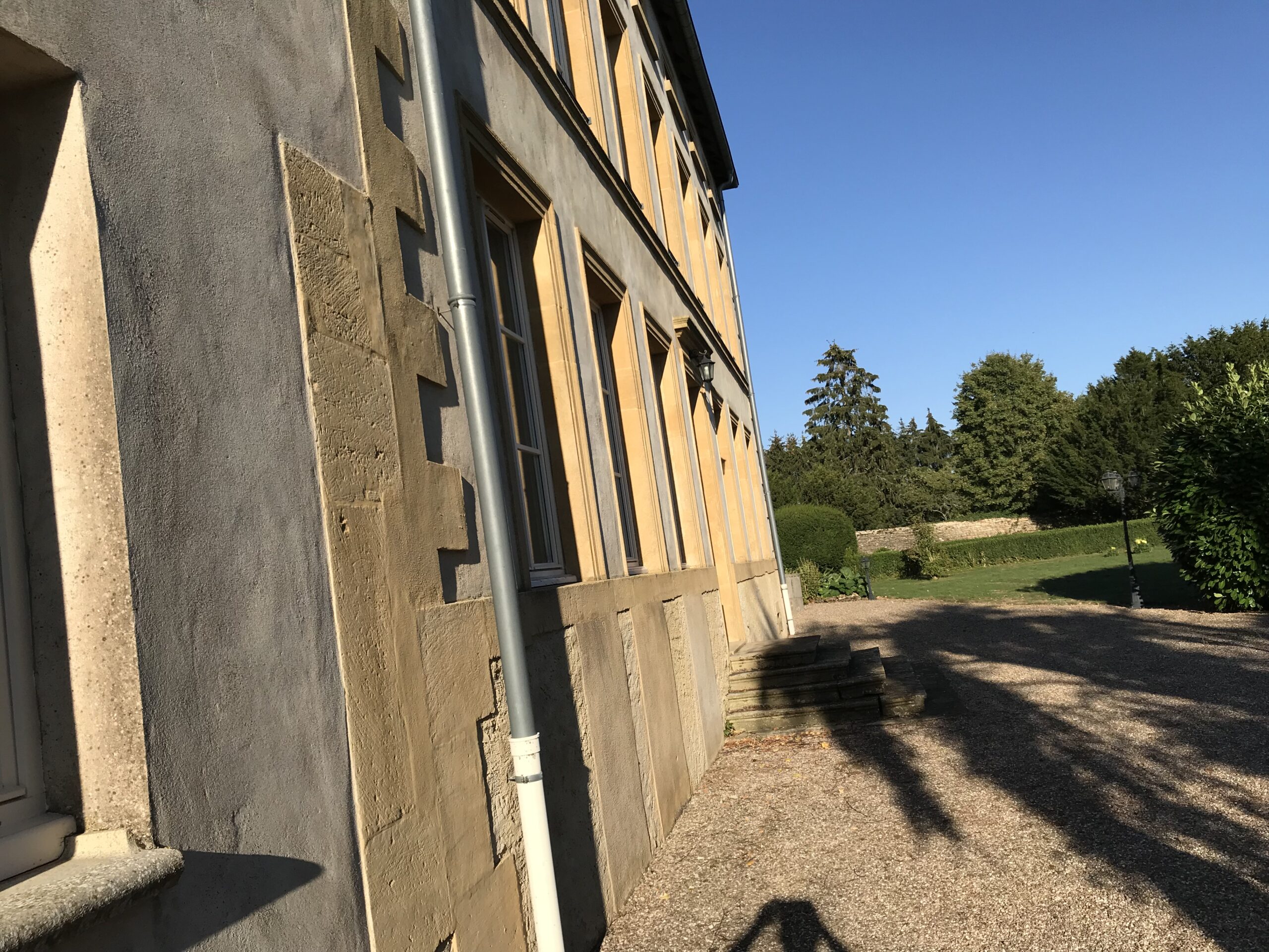 Boczna fasada Domaine de Gondrange w Havange oświetlona porannym słońcem
