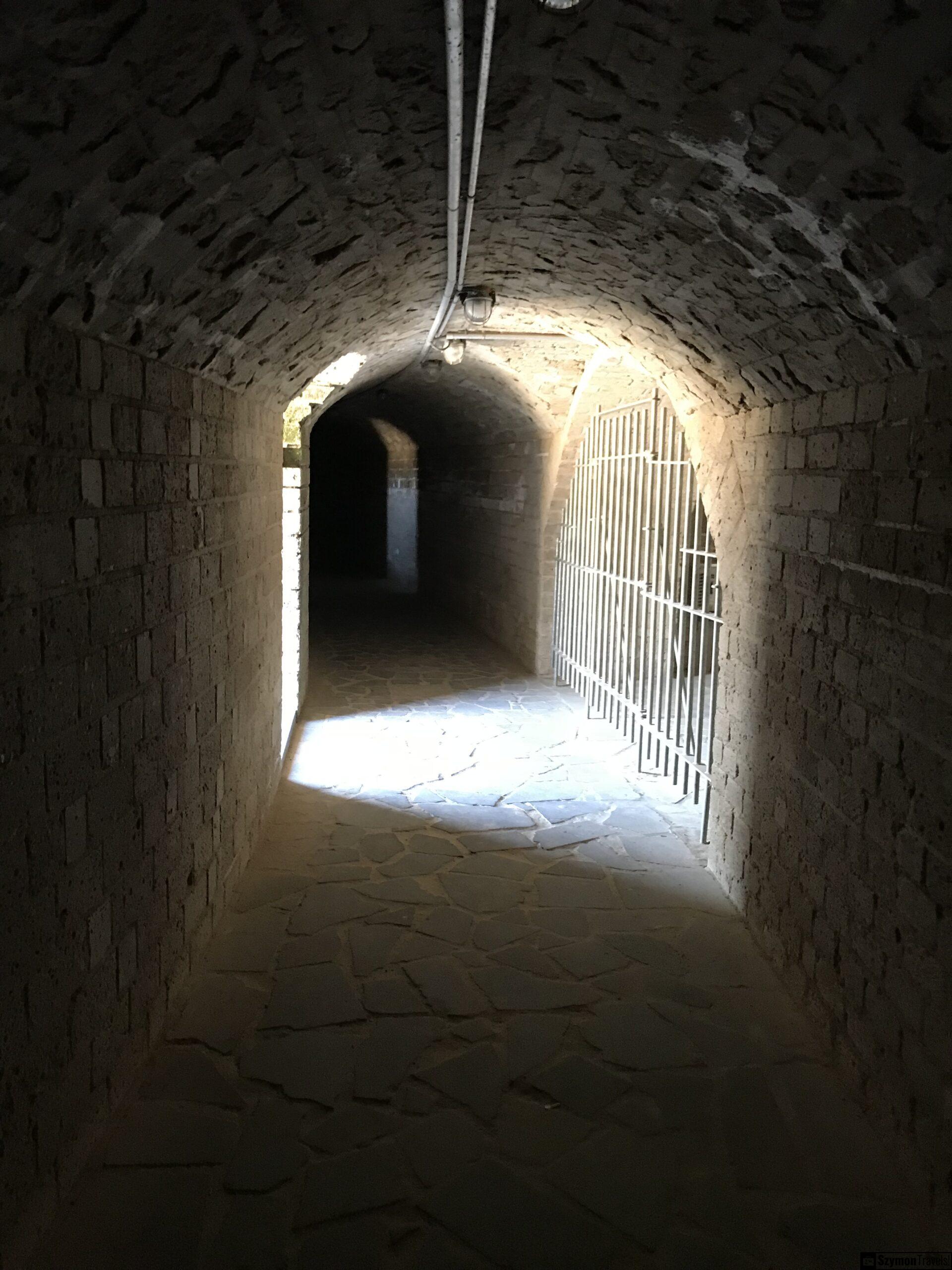 Tunel pod konstrukcją rzymską w APX Xanten Kamienny tunel z łukowym sklepieniem i kratą w rekonstrukcji rzymskiej architektury w APX Xanten